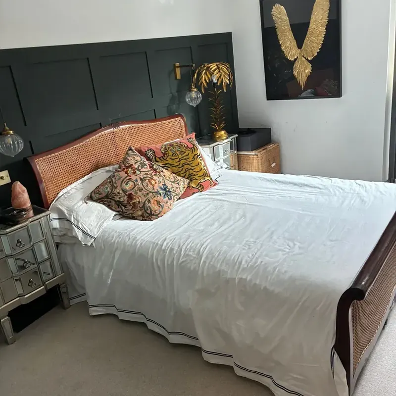 Made double bed with white bedding and cushions